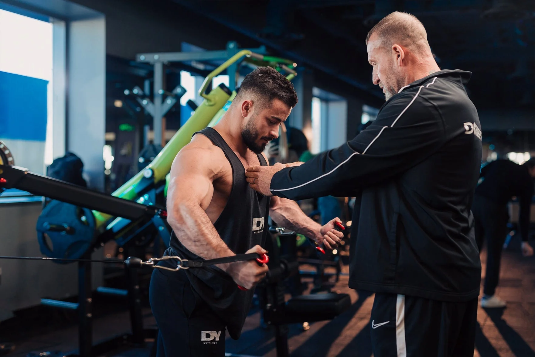 Dorian Yates coaching a lifter in the gym